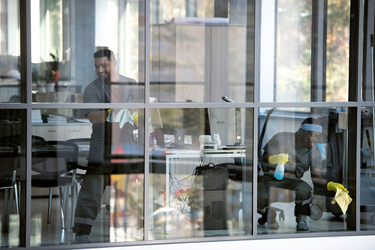 full-shot-smiley-man-cleaning-window_23-2149345512