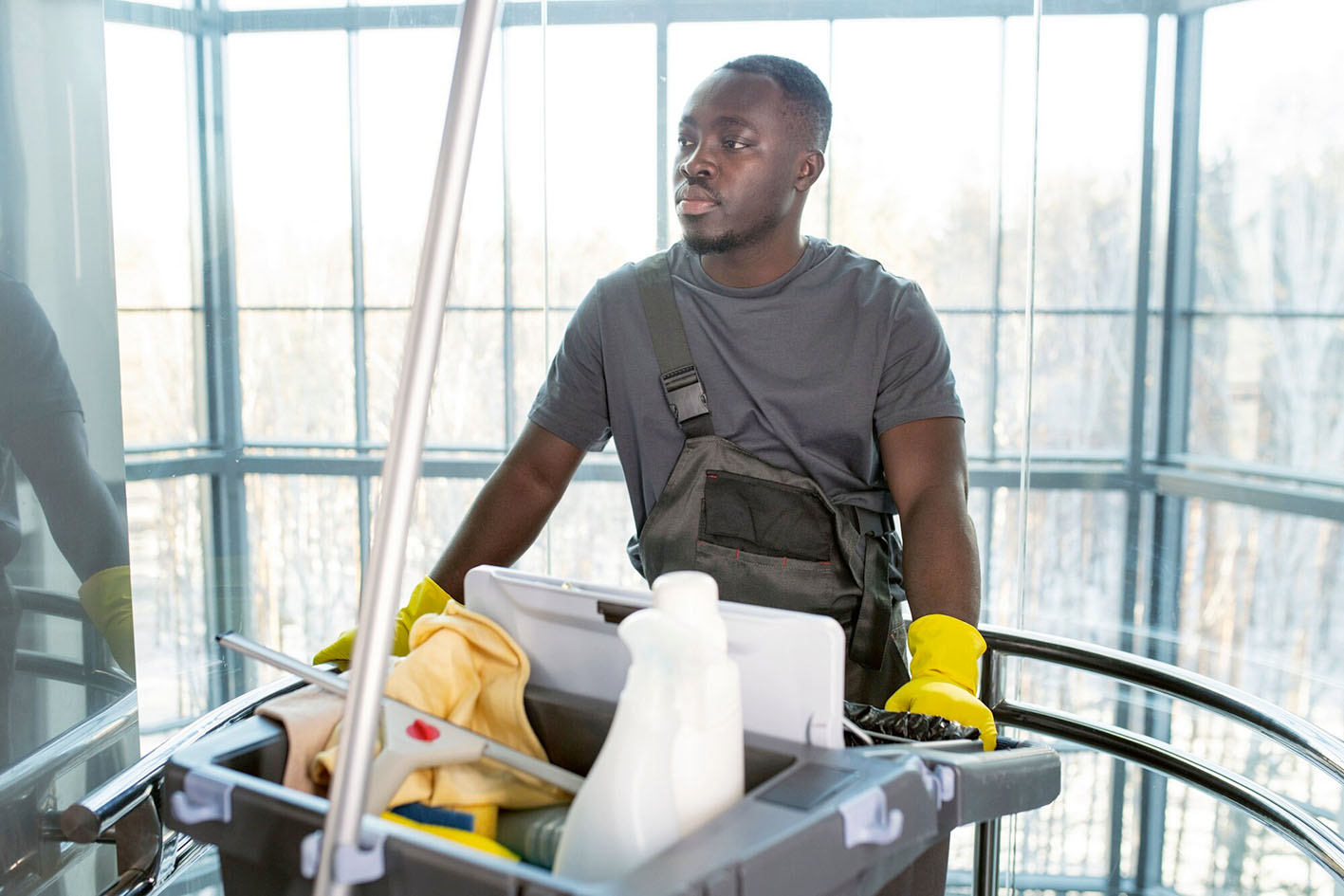 medium-shot-man-walking-with-cleaning-cart_23-2149345530